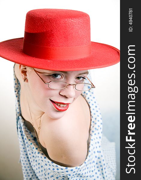 Portrait of young sexy smiling woman in red hat and polka-dot chemise. Portrait of young sexy smiling woman in red hat and polka-dot chemise