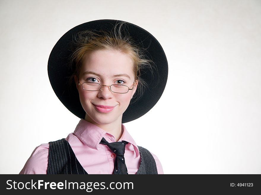 Portrait of young smiling business woman in black hat and suit