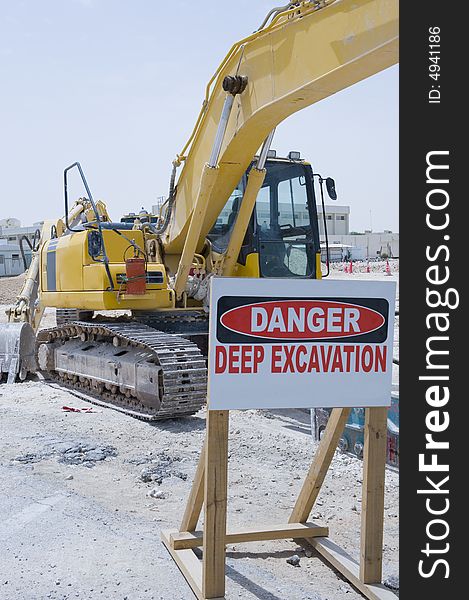 An industrial machine parked behind a danger sign.