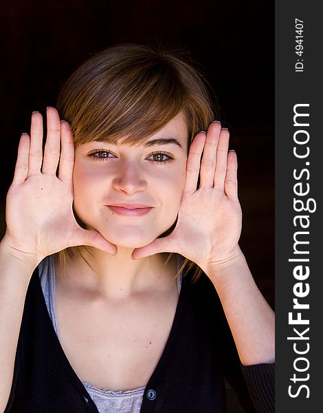 Beautiful blond woman framing herself with her hands. Beautiful blond woman framing herself with her hands