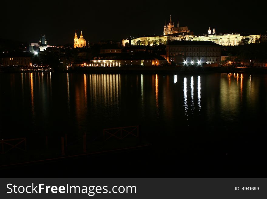 Night scene of Prague Castle, reflection on water, Vltava river