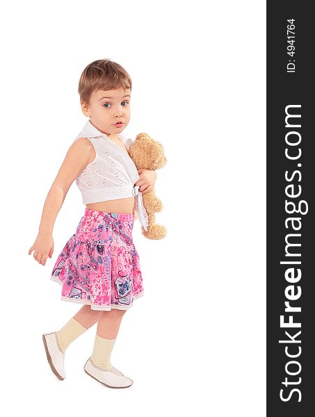 Little girl in skirt with toy on a white
