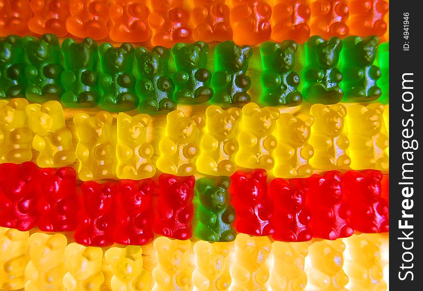 Colourful gummy bears lined up in rows