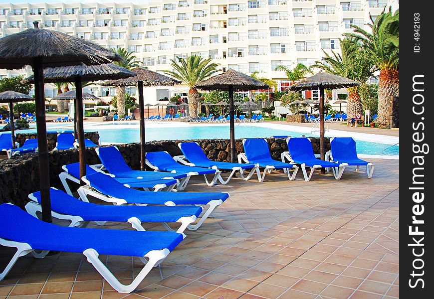 SPA resort on the Lanzarote. a pool area with blue chaise longue. SPA resort on the Lanzarote. a pool area with blue chaise longue