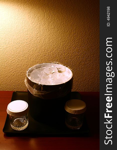 A photograph of a hotel ice bucket and glasses.