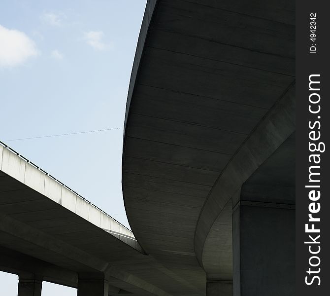 Under a concrete highway with blue sky