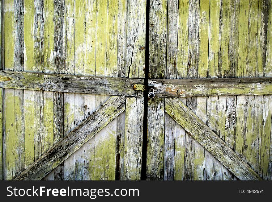 Detailed closeup of old wooden door on a building with a lock. Detailed closeup of old wooden door on a building with a lock