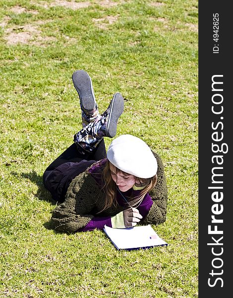 Woman painting on the grass in the park