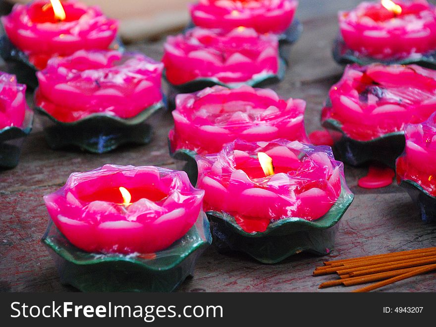 Burnging candles of lotus shape displayed before the Budda,Praying for Peace,joss sticks. Burnging candles of lotus shape displayed before the Budda,Praying for Peace,joss sticks.