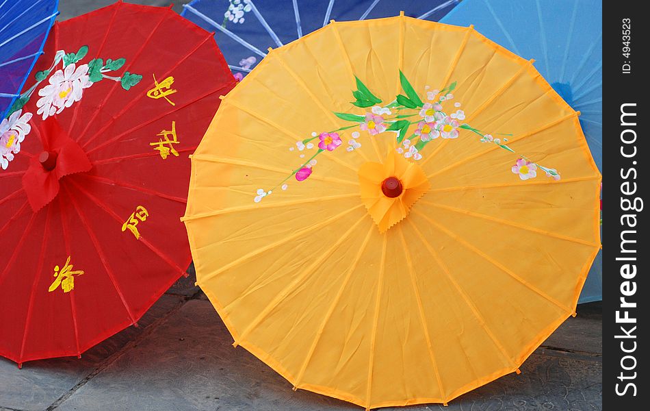 The ornamental sun umbrella made of colorful cloth with Chinese characters and paintings. The ornamental sun umbrella made of colorful cloth with Chinese characters and paintings.