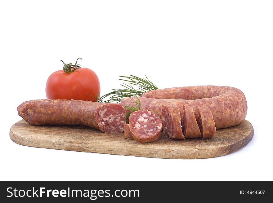 Sausage with tomato and dill on a wooden hardboard isolated on white