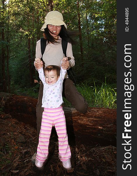 Baby girl first steps in the forest