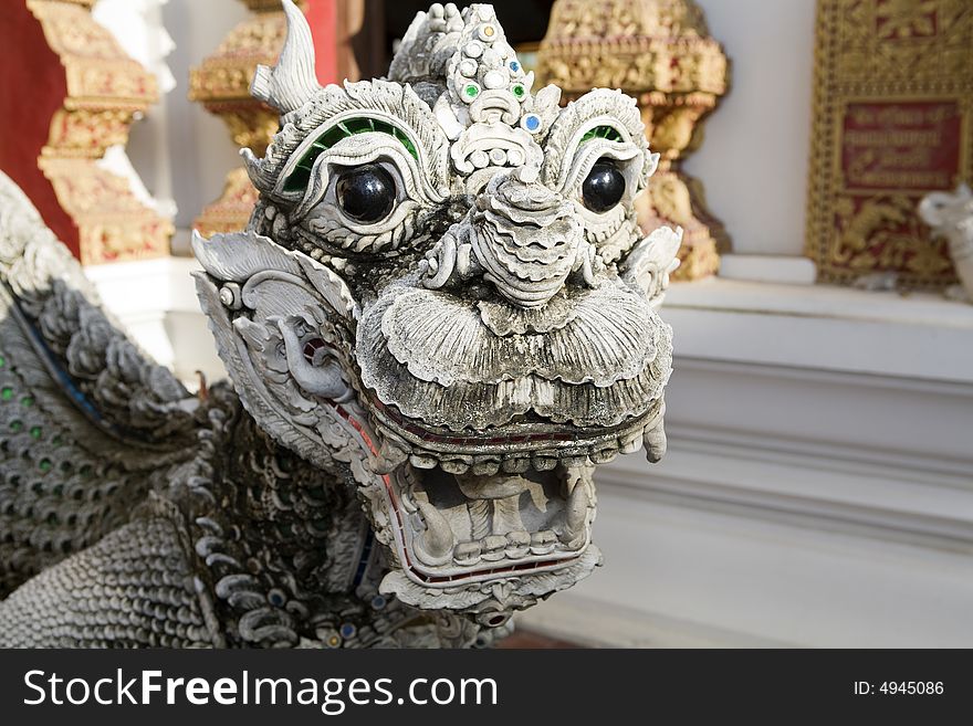 Dragon figure with a lion's head in a temple in Thailand. Dragon figure with a lion's head in a temple in Thailand