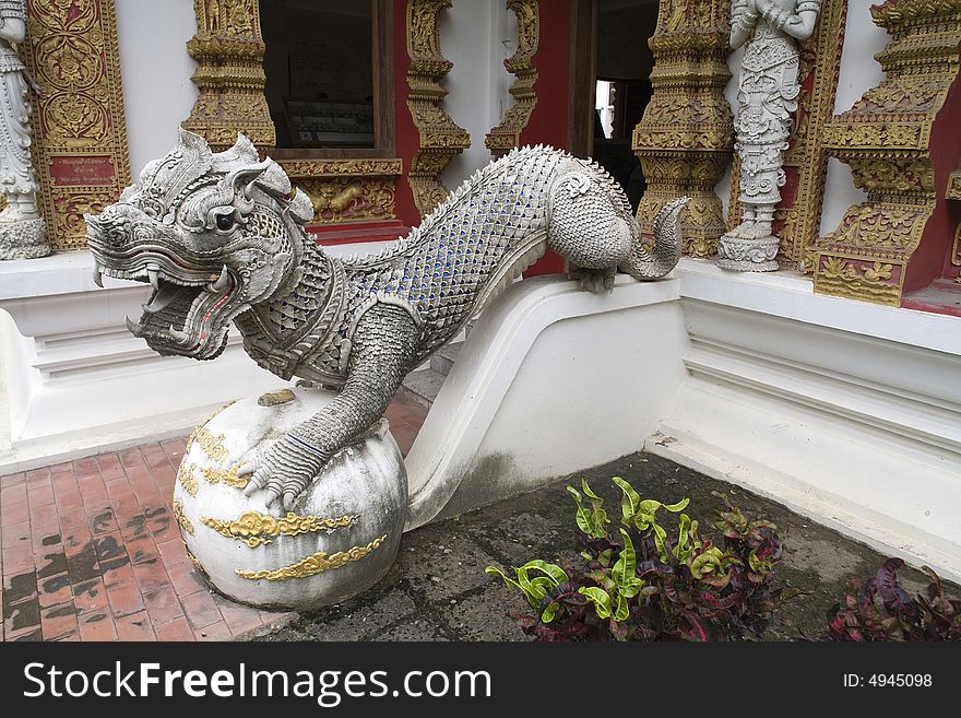 Dragon figure with a lion's head in a temple in Thailand. Dragon figure with a lion's head in a temple in Thailand