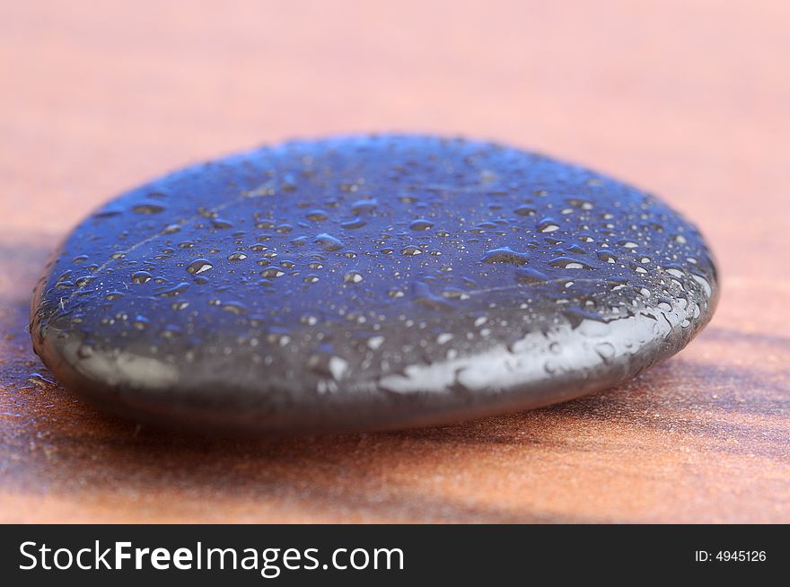 A black therapy stones with waterdrops