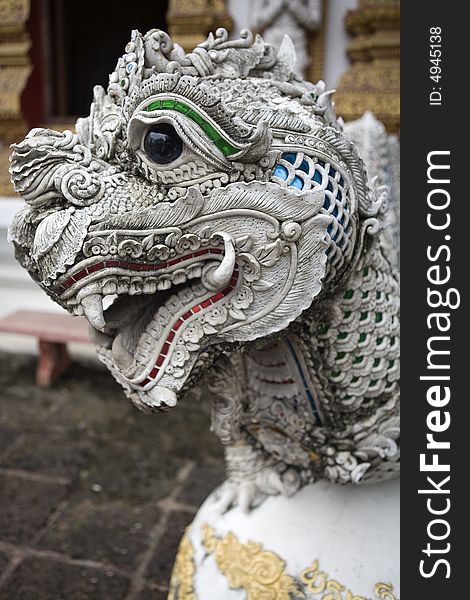 Dragon figure with a lion's head in a temple in Thailand. Dragon figure with a lion's head in a temple in Thailand