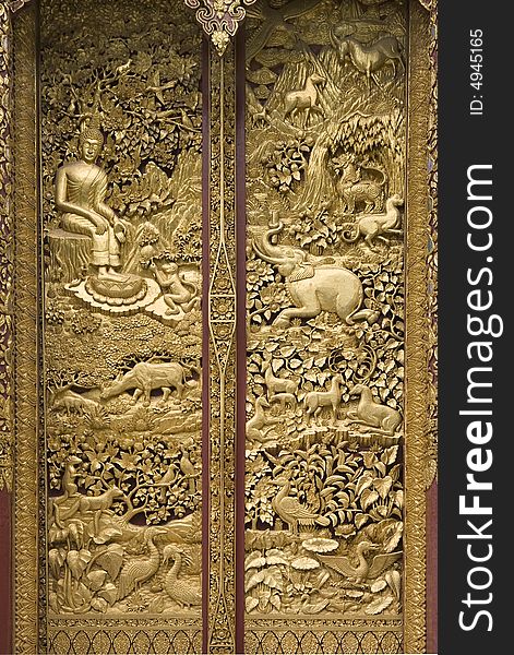 Gold relief door in a temple of Thailand