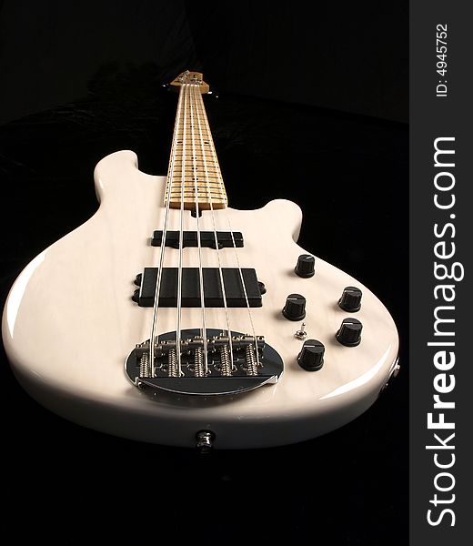 White Bass Guitar full length on black back ground. White Bass Guitar full length on black back ground