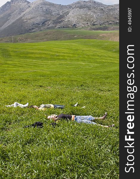 Two young friends resting on the grass. Two young friends resting on the grass