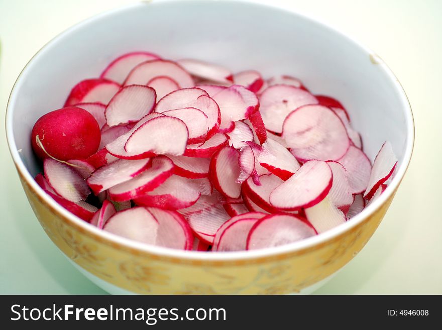 A salad of fresh red radishes with oil and vinegar