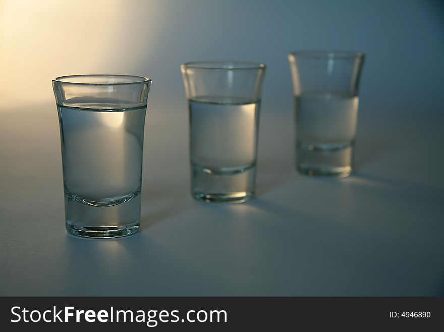 Three glasses full of alcohol, distance blur. Three glasses full of alcohol, distance blur