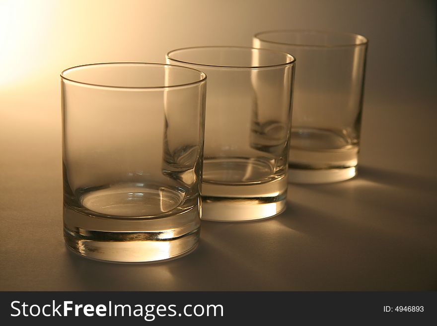 Three empty cognac glasses, distance blur. Three empty cognac glasses, distance blur