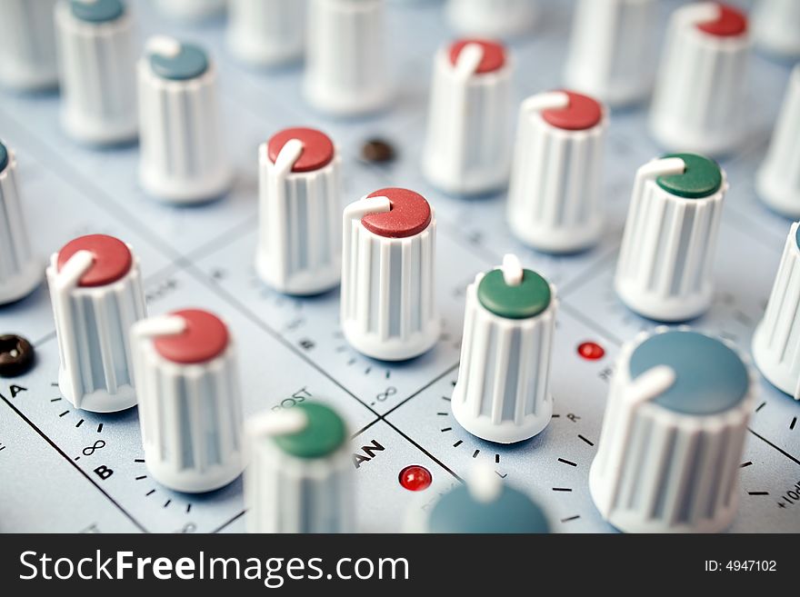 Closeup macro detail of a studio mixing console. Closeup macro detail of a studio mixing console