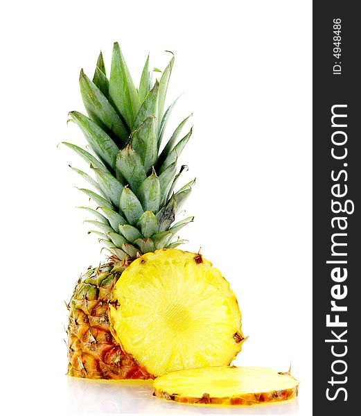 Fresh ripe pineapple with slices over white background