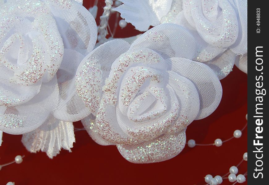 White wedding roses are decorated with beads. White wedding roses are decorated with beads.