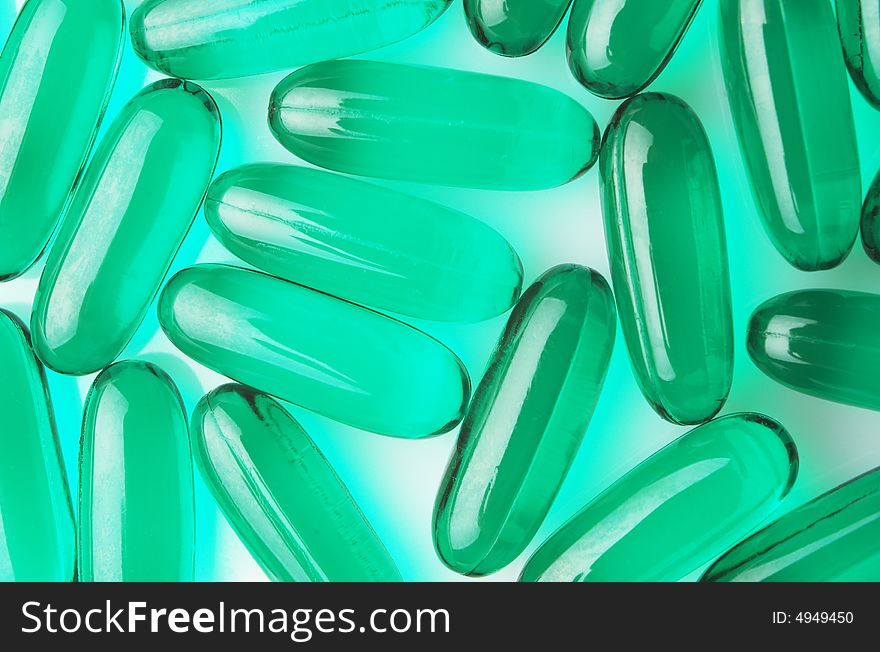 Green capsules on white background, horizontal image. Green capsules on white background, horizontal image