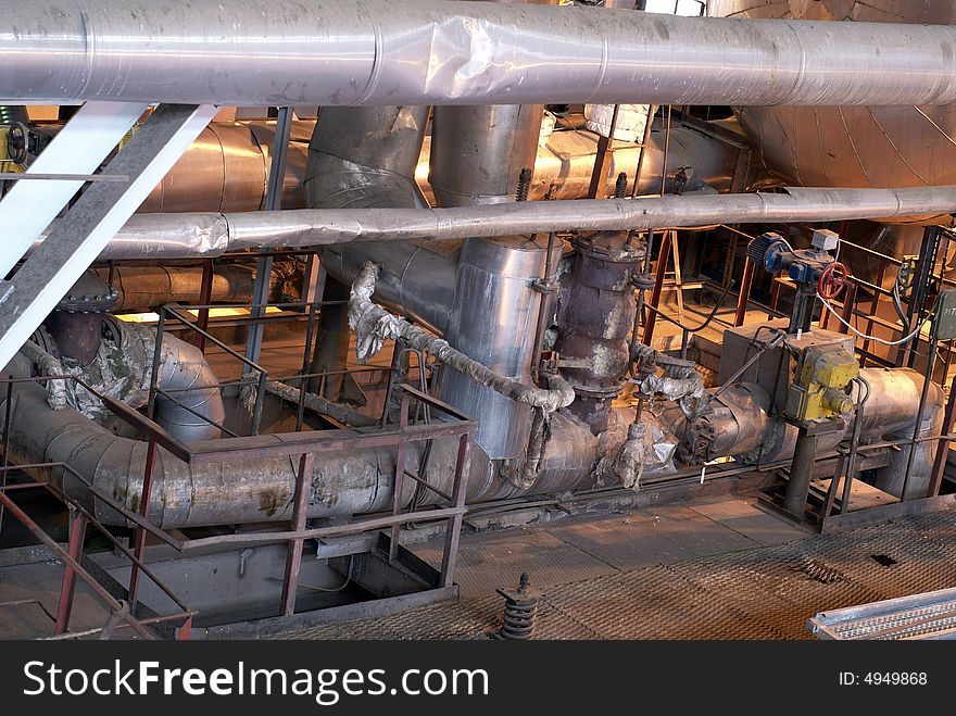 Equipment, cables and piping as found inside of a modern industrial power plant