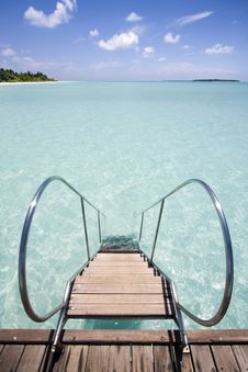 Jetty Leading Into Tropical Sea Royalty Free Stock Photo