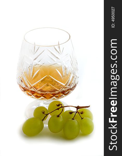 Glass of brandy or cognac with grapes. Glass of brandy or cognac with grapes