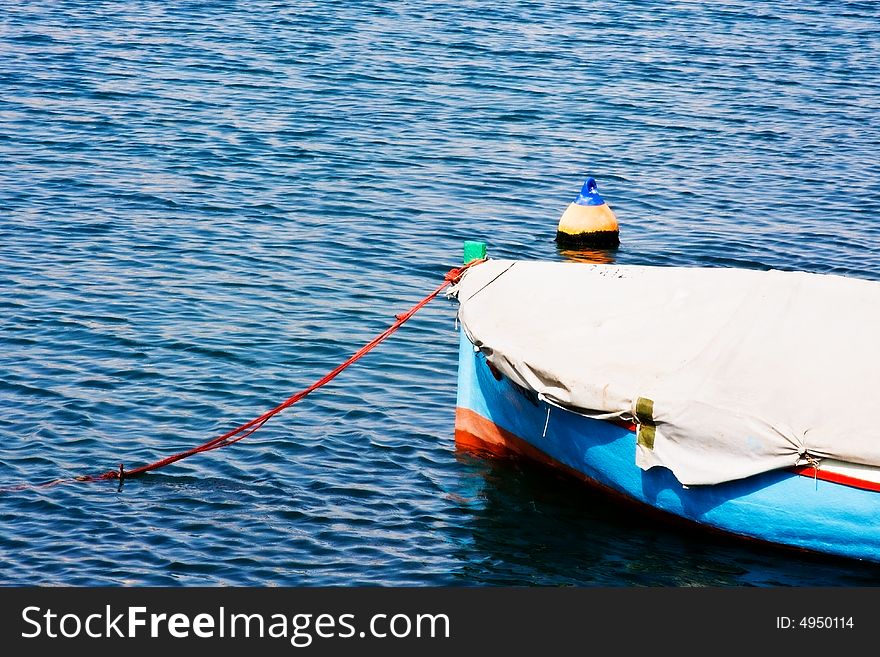 A fishing boat floating gently in the ocean.