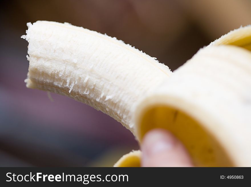 Ripe opened banana on abstract background