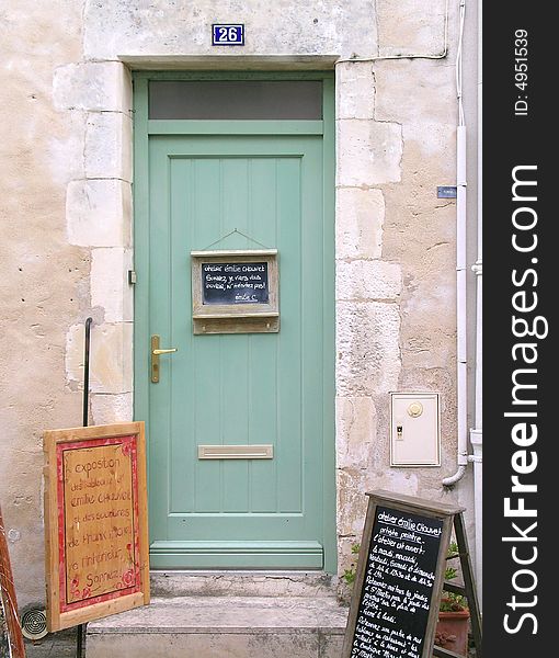 A green wooden door in France. A green wooden door in France.