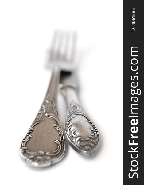 Ancient silver fork and knife isolated over white. Ancient silver fork and knife isolated over white