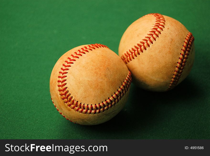 Two worn out old baseballs after a season of use. Two worn out old baseballs after a season of use