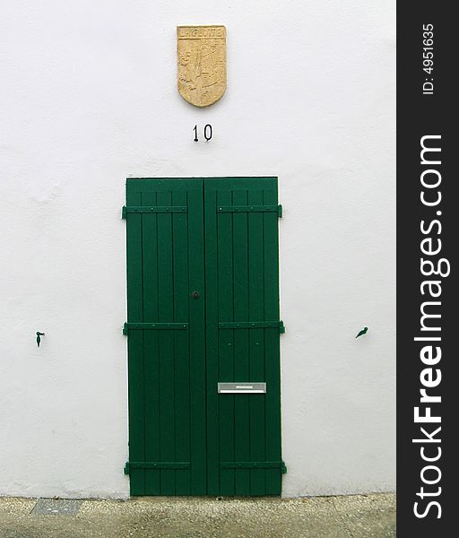 A green wooden door in France.