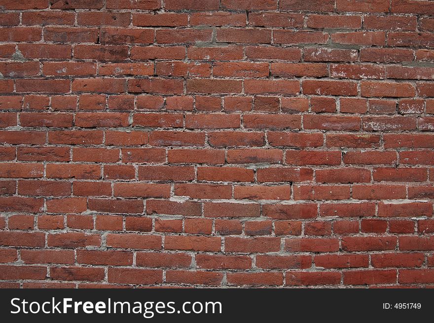 Dark red brick wall that could be used for a background. Dark red brick wall that could be used for a background