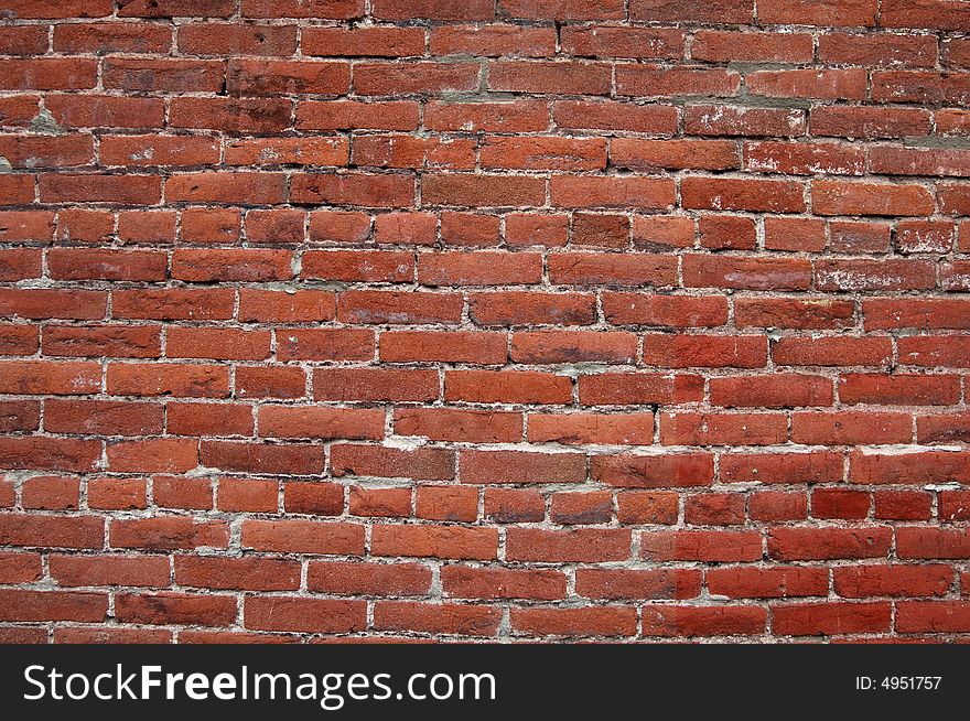 Dark red brick wall that could be used for a background. Dark red brick wall that could be used for a background