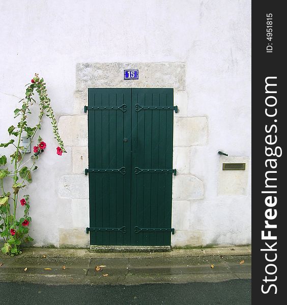 A green wooden door in France.