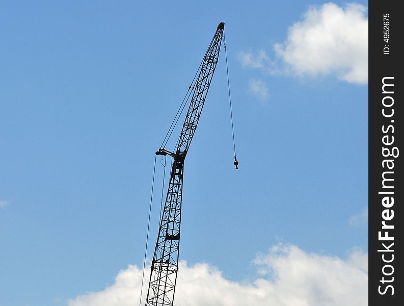 Construction crane highlighted against the sky