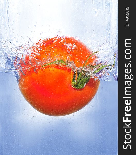 Splashing tomato into a water