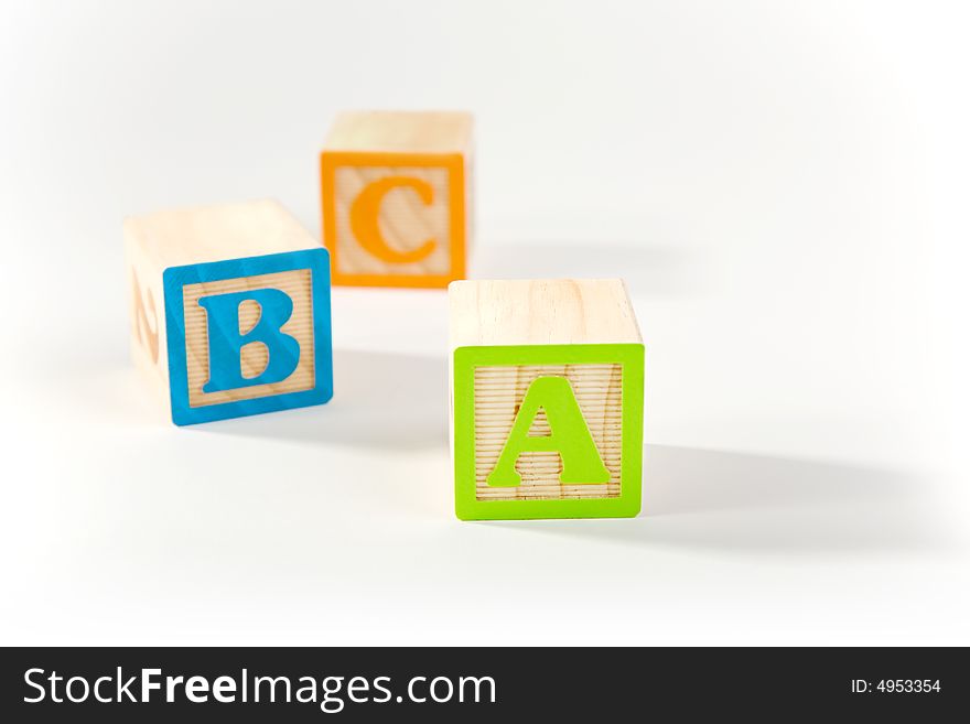Wooden ABC blocks laying on white surface