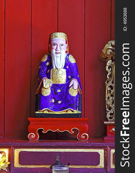 Malaysia, Penang: chinese temple; red background for this religious chinese statue