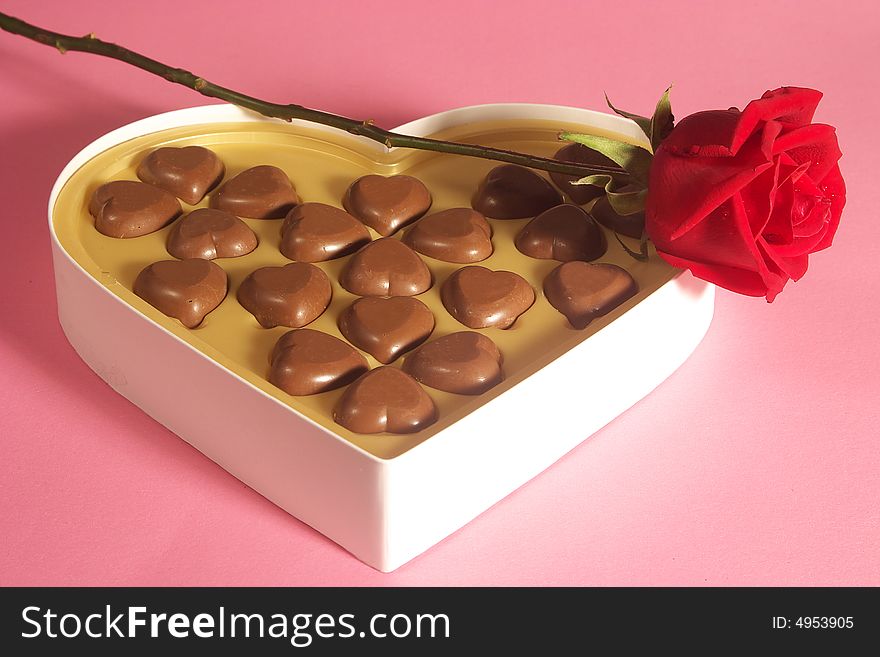 heart shape chocolates in box and rose