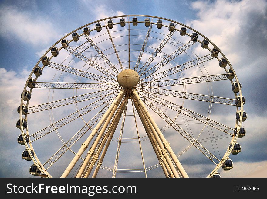 A view of a ferris wheel at an amusement park. A view of a ferris wheel at an amusement park