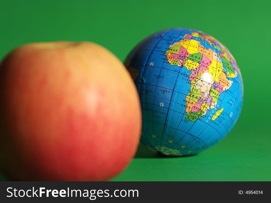 a globe and an apple . a globe and an apple
