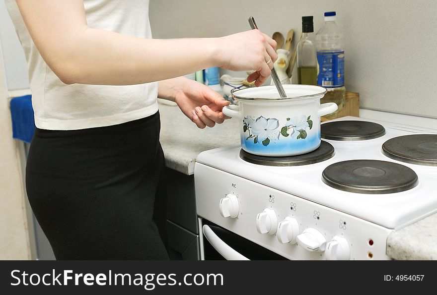 Woman cooking soup in the kitchen. Woman cooking soup in the kitchen